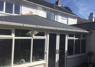 Conservatory with a White Frame and Grey Roof