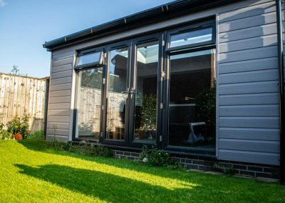 Home Extension with Light Grey Cladding and a Black Frame