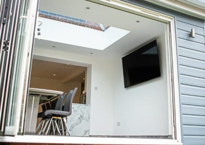 Home Extension with Light Blue Cladding and a White Frame